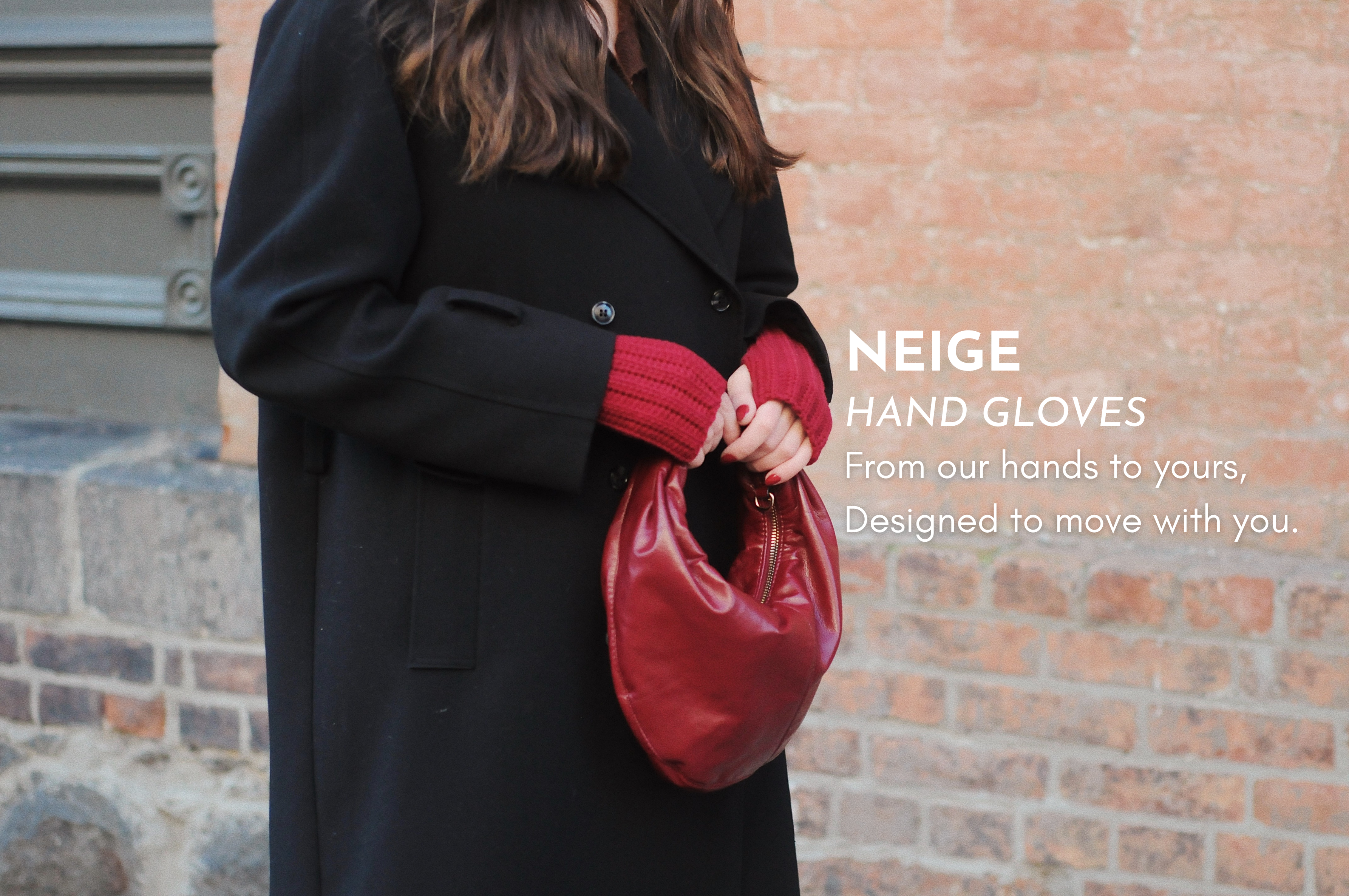 Person wearing a black coat and red gloves holding a red handbag against a brick wall, with 'Neige' branding.